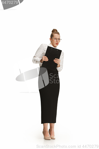 Image of Full length portrait of a frightened female teacher holding a folder isolated against white background