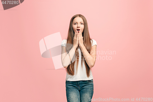 Image of Beautiful teen girl looking suprised isolated on pink
