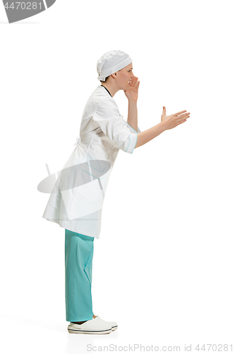 Image of Beautiful young woman in white coat posing at studio. Full length studio shot isolated on white.