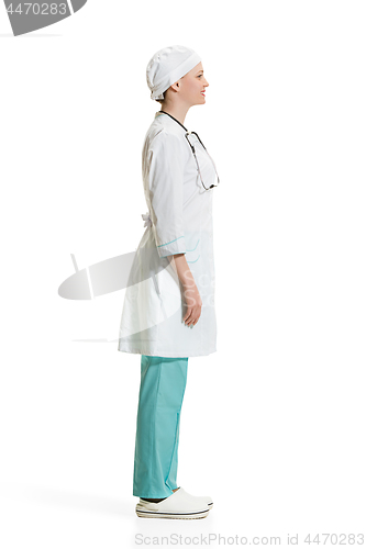 Image of Beautiful young woman in white coat posing at studio. Full length studio shot isolated on white.