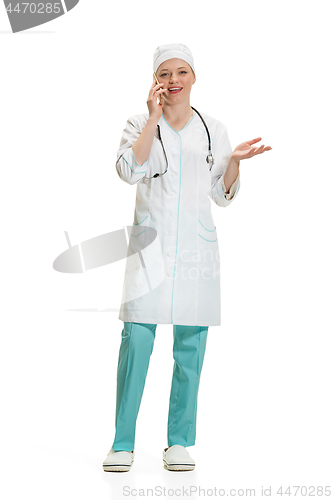 Image of Beautiful young woman in white coat posing at studio. Full length studio shot isolated on white.