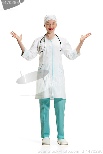 Image of Beautiful young woman in white coat posing at studio. Full length studio shot isolated on white.