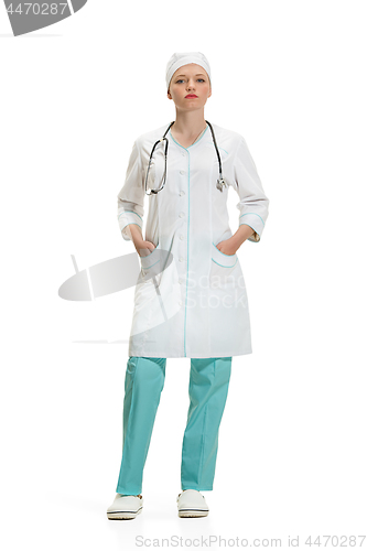 Image of Beautiful young woman in white coat posing at studio. Full length studio shot isolated on white.