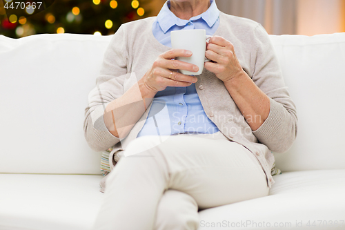 Image of close up of senior woman with tea cup on christmas