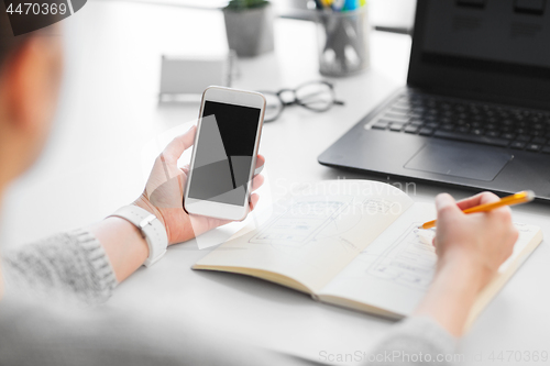 Image of web designer working on smartphone user interface