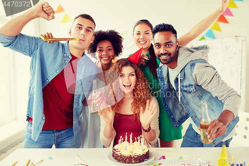 Image of happy coworkers with cake at office birthday party