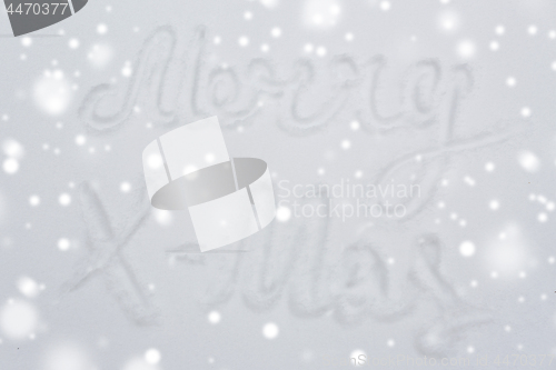 Image of merry christmas words on snow surface