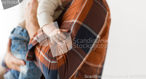 Image of close up of father holding little baby