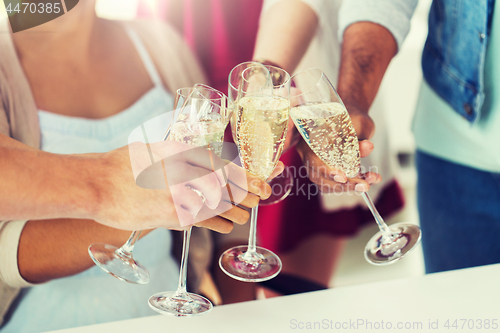 Image of friends clinking glasses of champagne at party