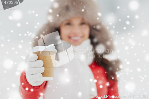 Image of happy woman with coffee cup in winter