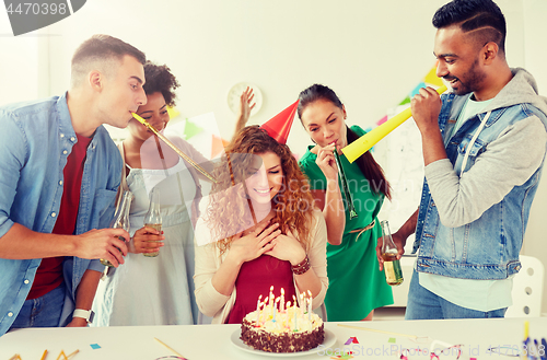 Image of happy coworkers with cake at office birthday party