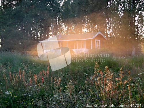 Image of House behind cloud in sunset light