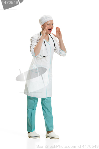 Image of Beautiful young woman in white coat posing at studio. Full length studio shot isolated on white.