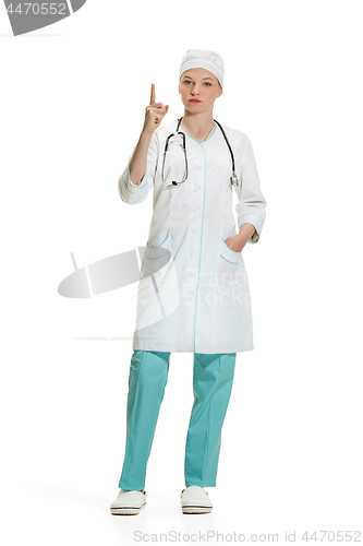 Image of Beautiful young woman in white coat posing at studio. Full length studio shot isolated on white.