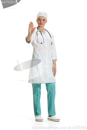 Image of Beautiful young woman in white coat posing at studio. Full length studio shot isolated on white.