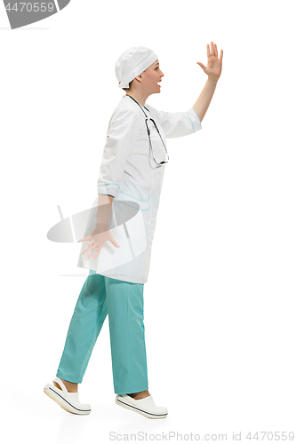 Image of Beautiful young woman in white coat posing at studio. Full length studio shot isolated on white.