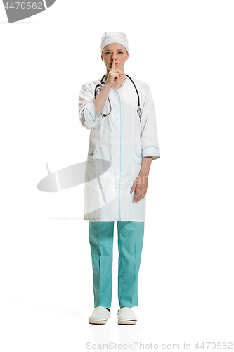 Image of Beautiful young woman in white coat posing at studio. Full length studio shot isolated on white.