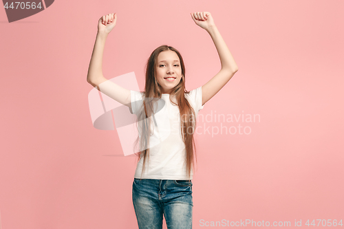 Image of Happy success teen girl celebrating being a winner. Dynamic energetic image of female model