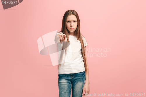 Image of The happy teen girl pointing to you, half length closeup portrait on pink background.