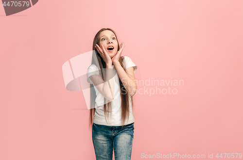 Image of Beautiful teen girl looking suprised isolated on pink