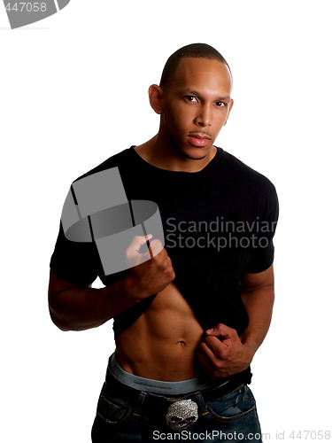 Image of Young black man holding up shirt in jeans