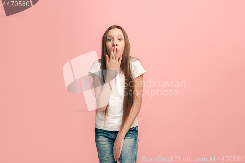 Image of Beautiful teen girl looking suprised isolated on pink