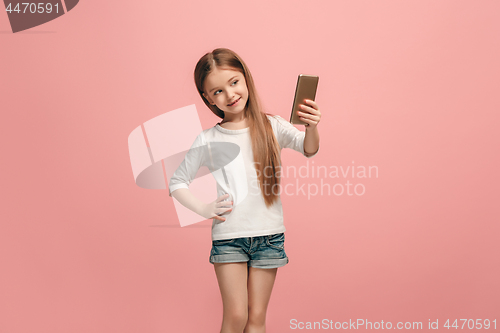 Image of The happy teen girl making selfie photo by mobile phone