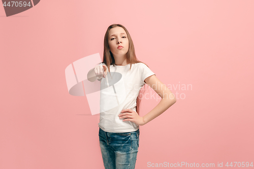 Image of The teen girl pointing to you, half length closeup portrait on pink background.