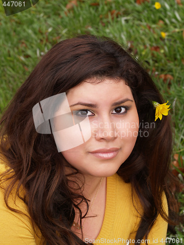 Image of Young plump woman yellow sweater with flower