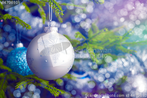 Image of Christmas-tree decoration bauble on decorated Christmas tree bac