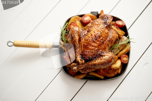 Image of Roasted whole chicken in cast iron black pan