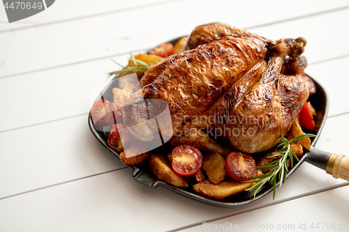 Image of Roasted whole chicken in cast iron black pan