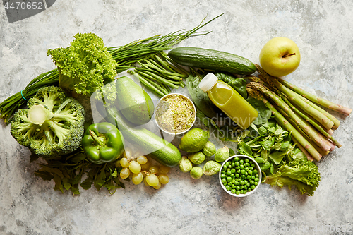 Image of Green antioxidant organic vegetables, fruits and herbs placed on gray stone