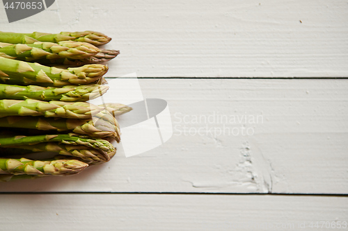 Image of Above view of flat-lay organic raw uncooked green asparagus