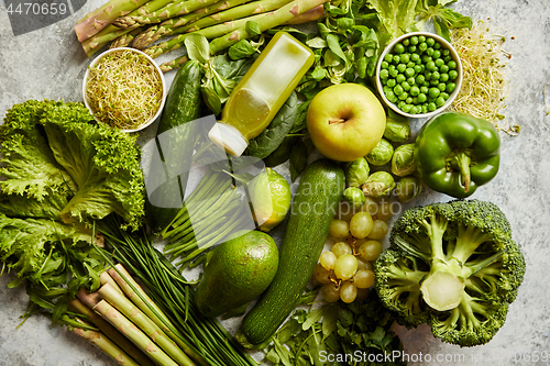 Image of Green antioxidant organic vegetables, fruits and herbs placed on gray stone