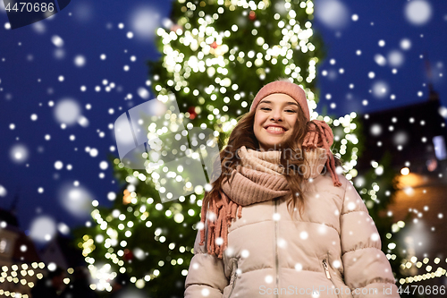 Image of happy young woman at christmas in winter