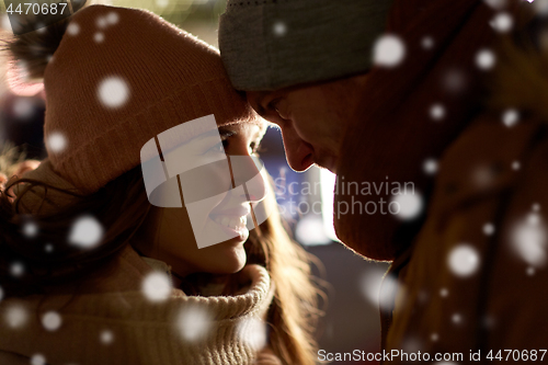 Image of close up of happy couple in winter clothes