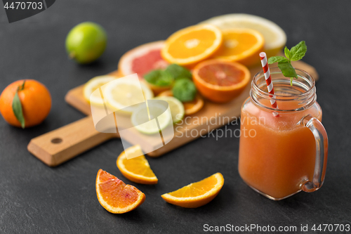 Image of mason jar glass of fruit juice on slate table top