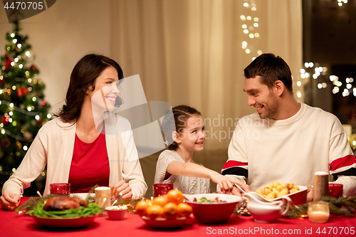 Image of happy family having christmas dinner at home