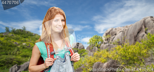 Image of happy woman with backpack over seychelles island