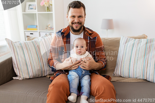 Image of happy father with little baby boy at home