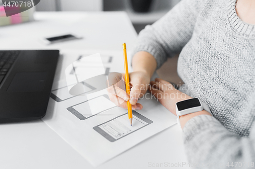 Image of web designer working on user interface at office