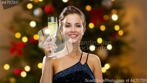 Image of woman with glass of champagne on christmas