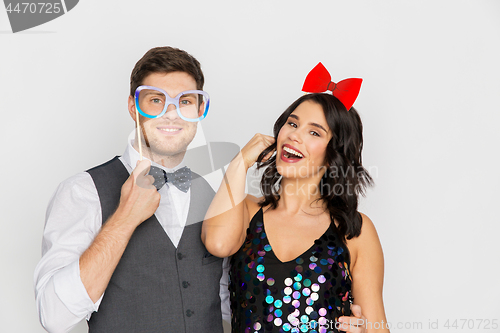 Image of happy couple with party props having fun