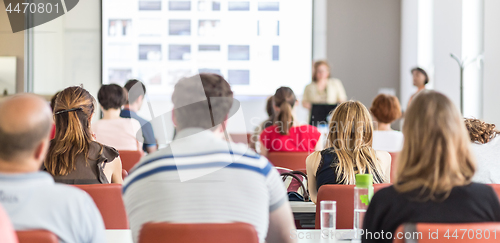 Image of Woman giving presentation in lecture hall at university.