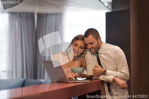 Image of A young couple is preparing for a job and using a laptop