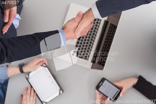 Image of cloasing the deal in modern office interior top view