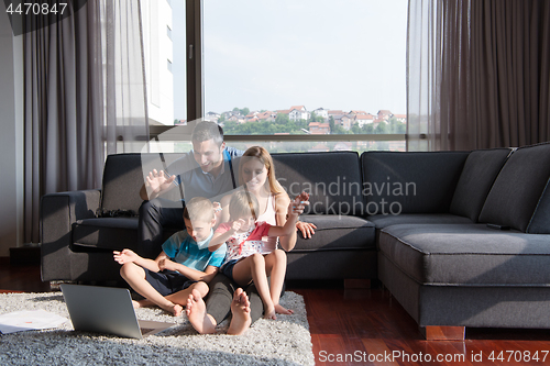 Image of Family Playing Together with laptop computer