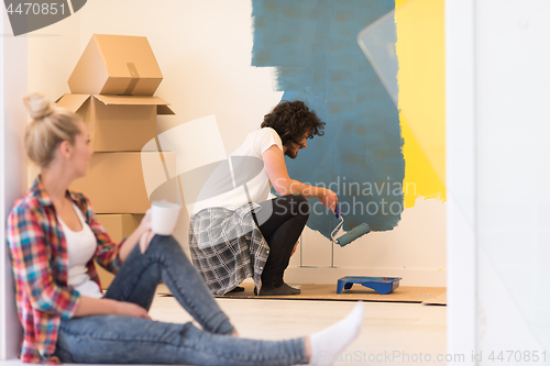 Image of young couple doing home renovations