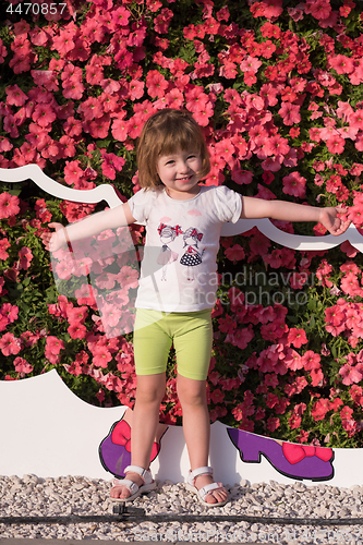 Image of little cute girl in a flower garden